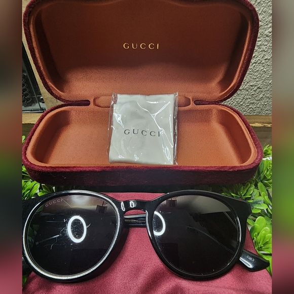Gucci sunglasses with case, bag, and cleaner